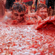 Image for article titled Photos: Spaniards mark another year by gleefully smashing each other in the face with tomatoes